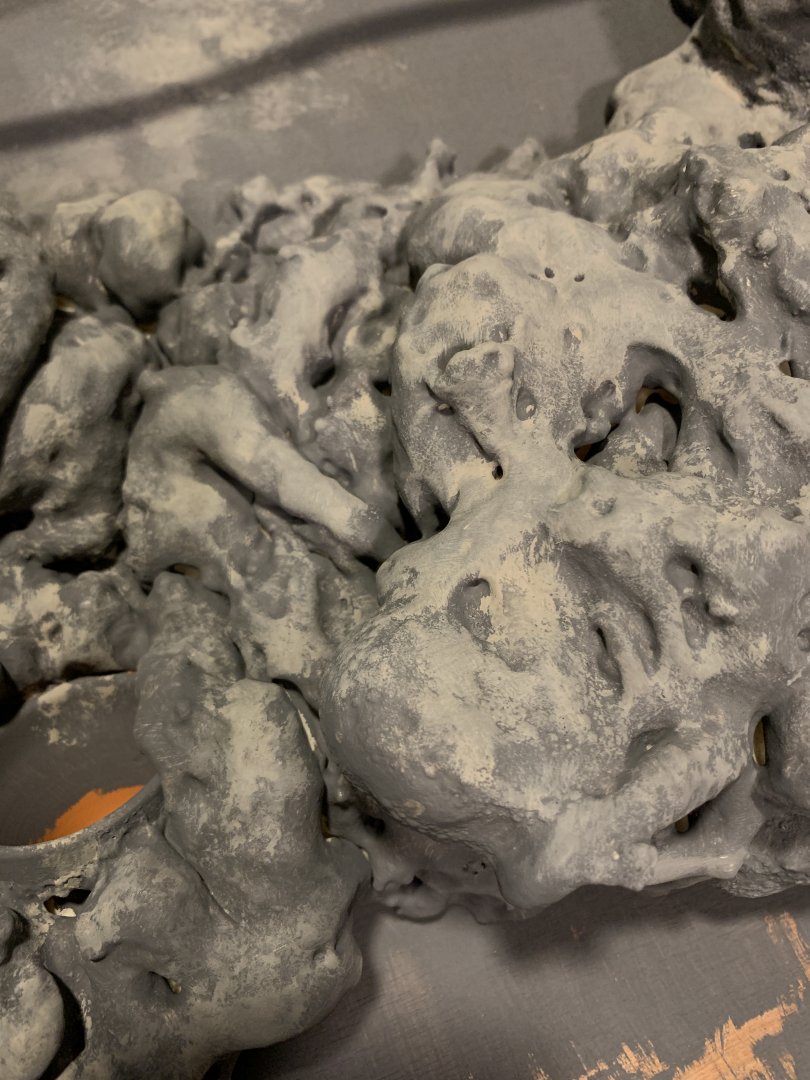 First few layers of paint on the faux rock wall.