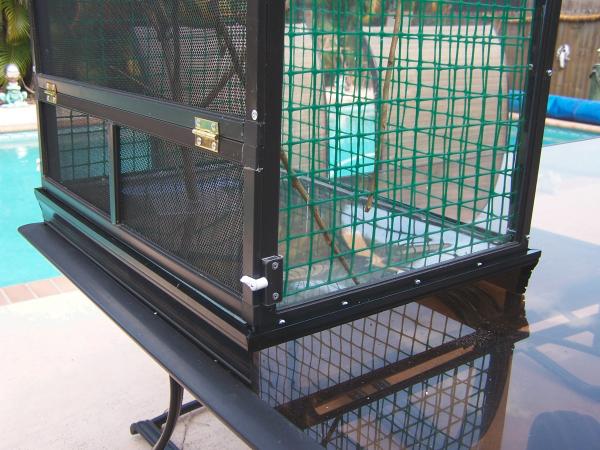 Right side of cage stand open for drain pan to slide in and out